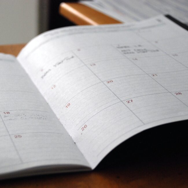 Monthly calendar book open on a table for rental properties in Southeast Missouri