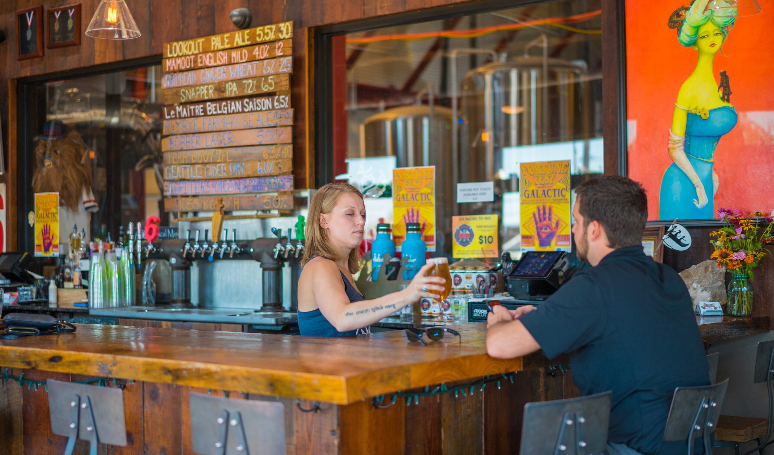 Waitress serving a beer to a man at the Minglewood Brewery located in Southeast Missouri
