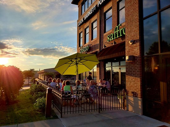 People eating outside with a sunset background at Bistro Saffron in Southeast Missouri