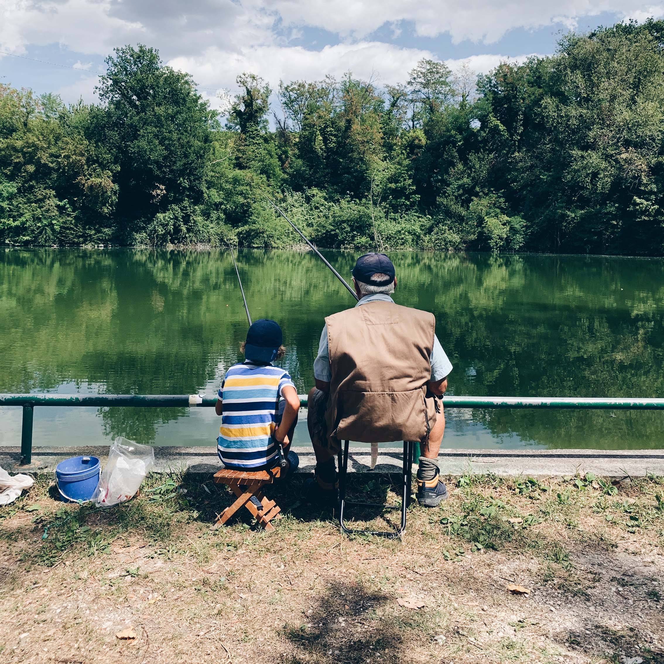 Grandpa and grandson fishing together at a pond located in Southeast Missouri