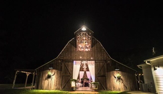 Barn with lights shining from it at night at Rusted Route Farms wedding venue located in Southeast Missouri