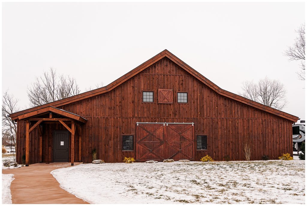 Dark brown barn with snow on the ground at Sweet Pecan Farms wedding venue located in Southeast Missouri