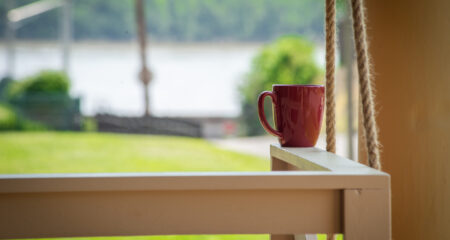 Coffee cup on the front porch swing at the Mississippi Queen rental home located in Southeast Missouri